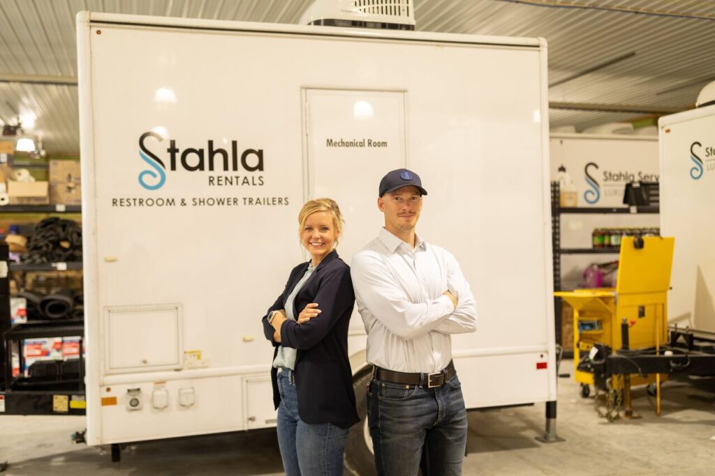 Stahla team member cleaning a branded trailer